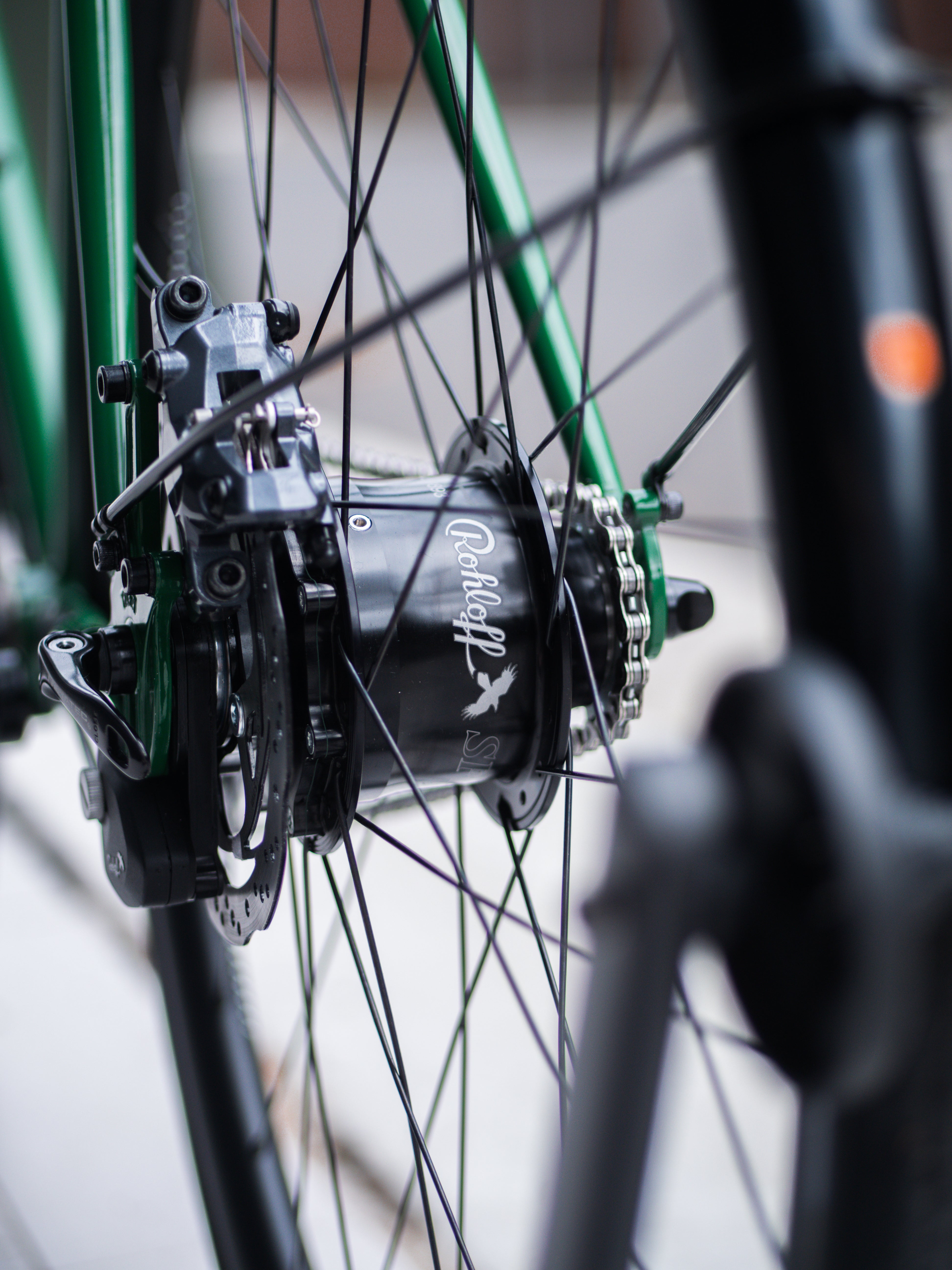 Close-up of a bicycle hub with a brand logo on a blurred background